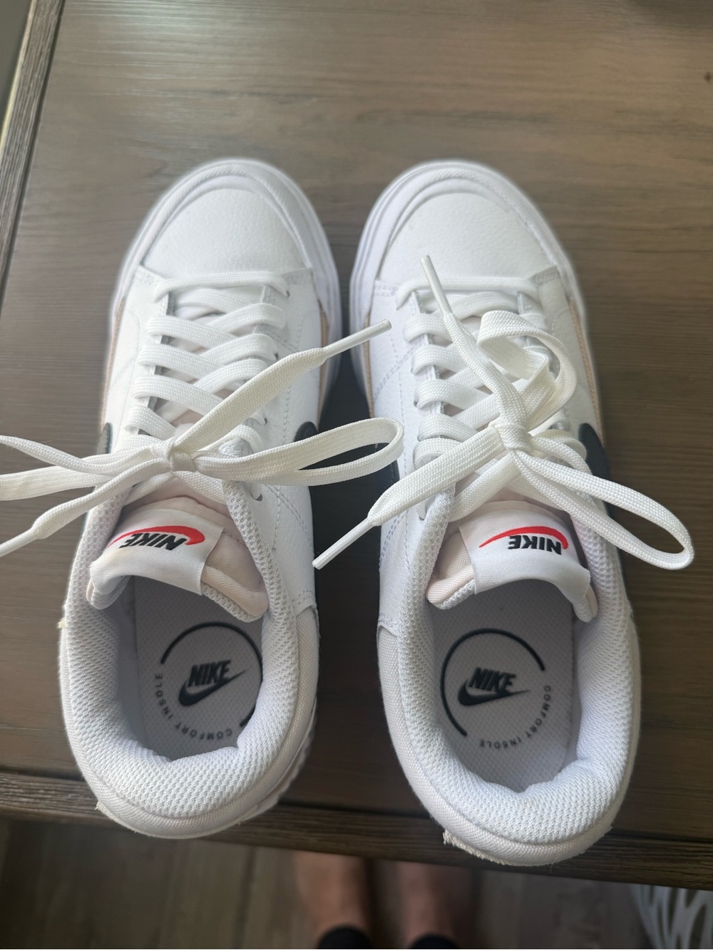 Nike White Low-Top Lace-Up Sneakers with Black Swoosh